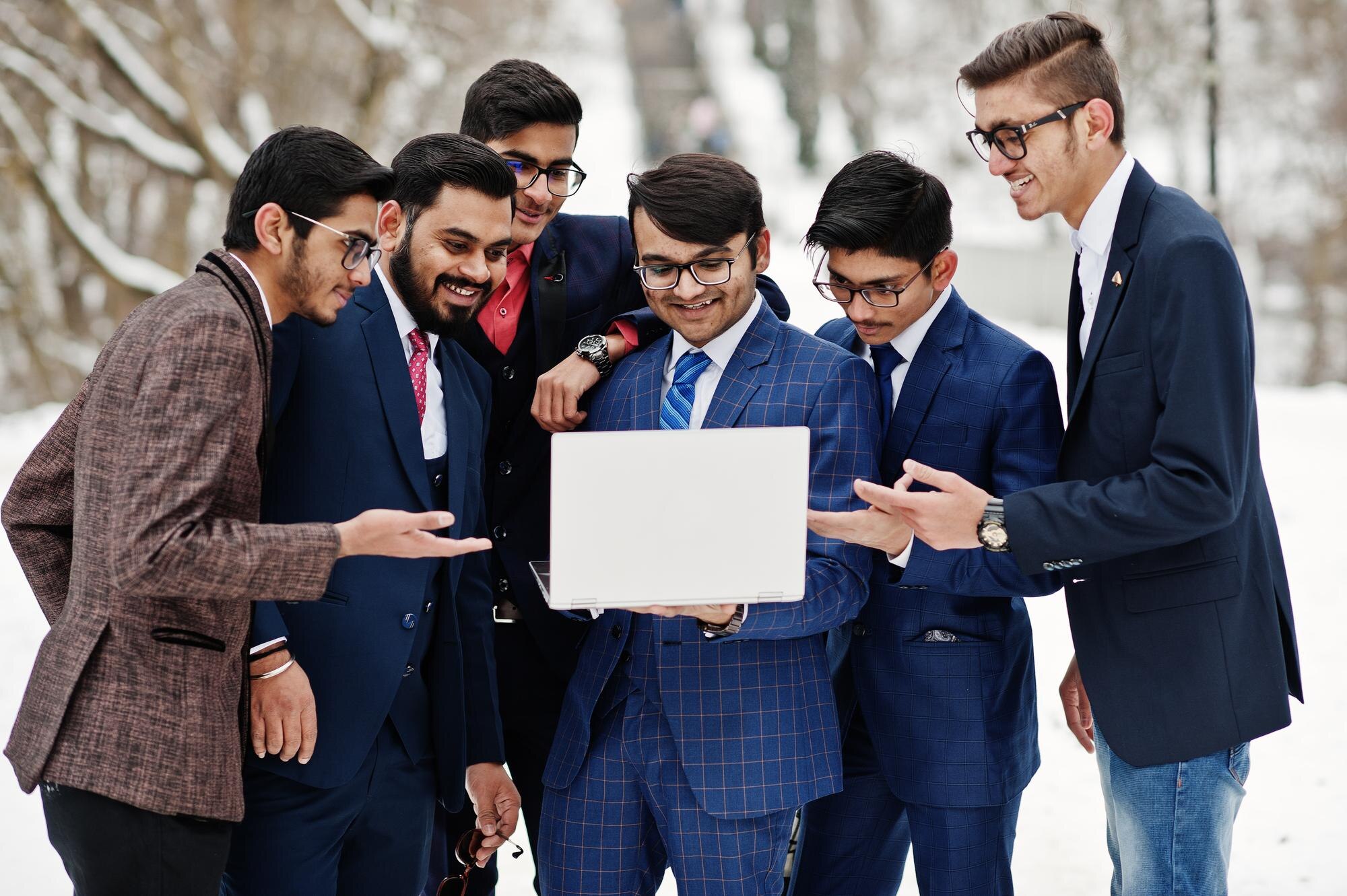 group-six-indian-businessman-suits-posed-outdoor-winter-day-europe-looking-laptop_627829-13345